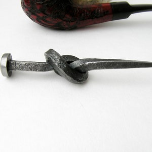 Convenient forged tamper in the form of a knotted nail