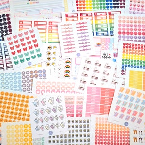 May include: Assortment of colorful planner stickers featuring various designs, including bows, clouds, suns, rainbows, and smiley faces. The stickers are arranged in a random pattern on a white background.