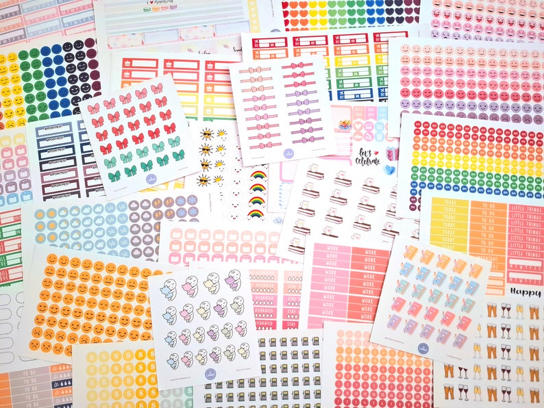 May include: Assortment of colorful planner stickers featuring various designs, including bows, clouds, suns, rainbows, and smiley faces. The stickers are arranged in a random pattern on a white background.
