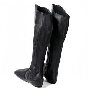 A pair of black leather boots with a pointed toe and a high, pointed heel.