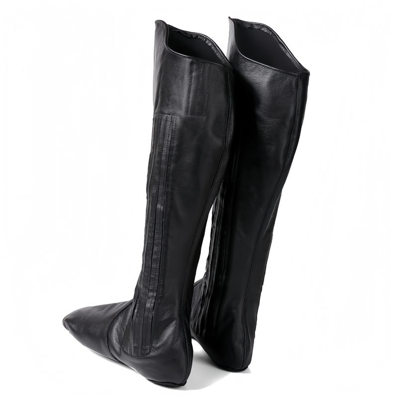 A pair of black leather boots with a pointed toe and a high, pointed heel.