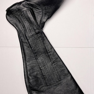 A black leather boot is shown in the image.