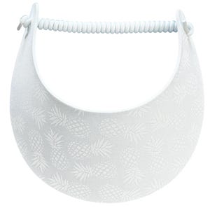 May include: White visor with a repeating pineapple pattern. The visor has a curved brim and a coiled headband. The pineapple design is embossed on the visor's surface. The visor is designed to shield the eyes from the sun.