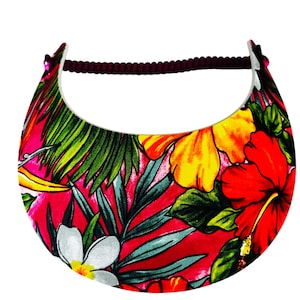 May include: A vibrant visor featuring a tropical floral print. The visor has a red background with yellow, red, and white flowers, green leaves, and a dark brown headband. The visor is designed to shield the eyes from the sun.