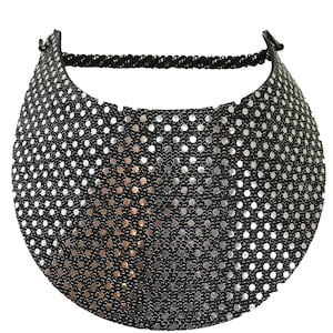 May include: A black visor with silver sequins in a polka dot pattern. The visor has an adjustable strap.