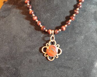 Red Tiger Eye all natural Necklace handmade open flower pedals in. Genuine Copper with matching pierced copper earrings.
