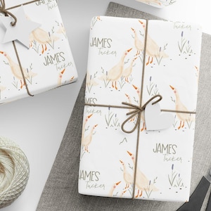 May include: White wrapping paper with a repeating pattern of watercolour geese and the name "JAMES TUCKER" printed in brown text.