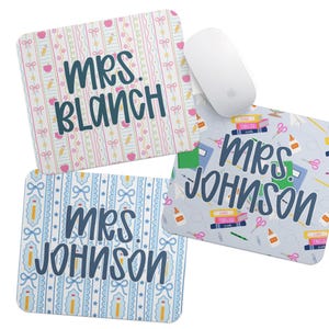 May include: Three personalized mouse pads with teacher-themed designs. One pad features the name "Mrs. Blanch" on a pink and white striped background with bows, pencils, and apples. Two pads say "Mrs. Johnson" with school supplies.