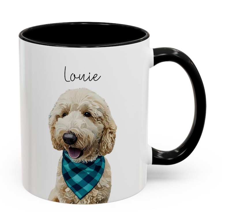 May include: White ceramic mug with a black handle and rim. The mug features a portrait of a Goldendoodle dog wearing a blue and teal plaid bandana. The dog's name, "Louie," is written above the dog's head in black script.