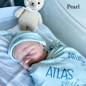 Custom baby name swaddle and blanket set perfect for newborn photos, hospital pictures, and birth announcements. Personalized swaddle blanket makes a meaningful keepsake gift for baby boys or girls with a timeless, boutique-style design.