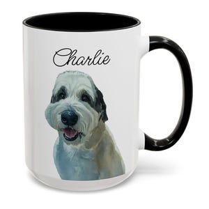 May include: White ceramic mug with a black interior and handle. The mug features a watercolor illustration of a dog with the name "Charlie" in script above the dog's head. The dog has white and tan fur.