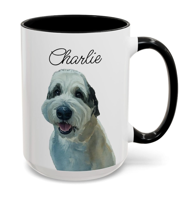 May include: White ceramic mug with a black interior and handle. The mug features a watercolor illustration of a dog with the name "Charlie" in script above the dog's head. The dog has white and tan fur.