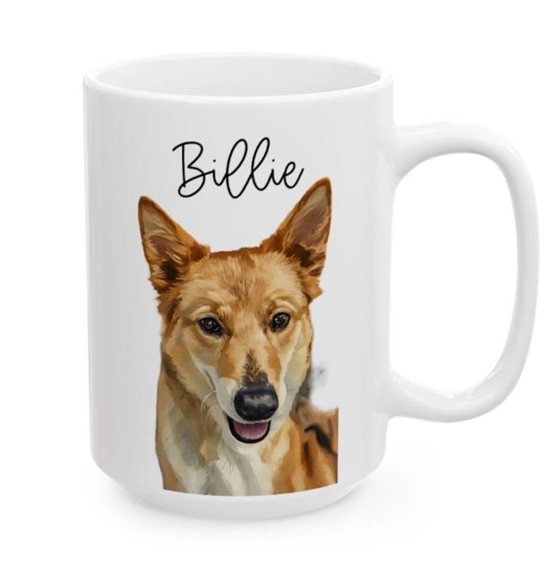 May include: White ceramic mug featuring a portrait of a dog with brown and tan fur. The dog's name, "Billie," is written in black script above the dog's head. The mug has a large handle and a glossy finish.