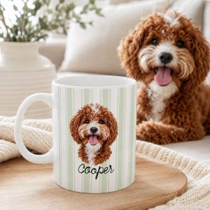 May include: A white ceramic mug featuring a light green and white vertical striped pattern. The mug displays a detailed illustration of a brown and white curly-haired dog with its tongue out, positioned above the name Cooper in black script text.