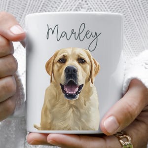 May include: White ceramic mug featuring a golden Labrador Retriever portrait with the name "Marley" in script. The dog's open mouth and pink tongue are visible. A personalized pet-themed gift.