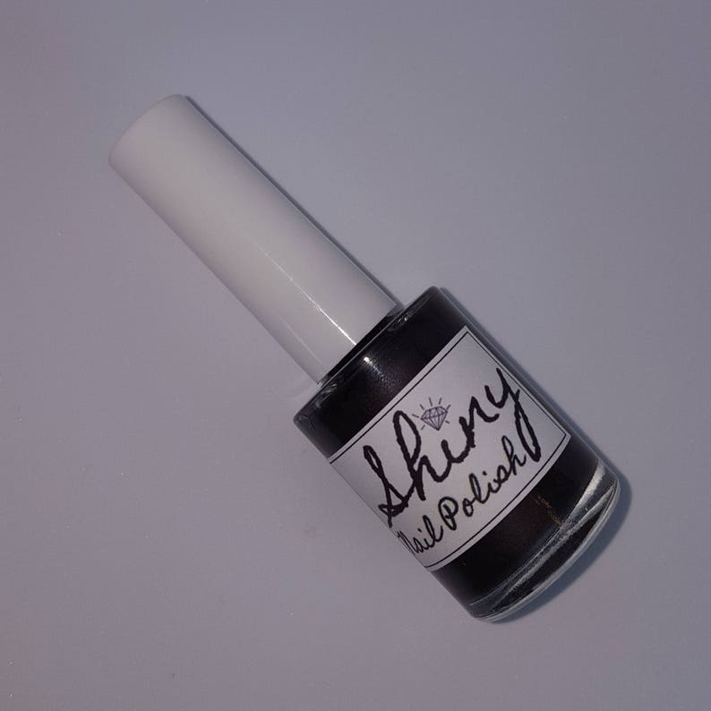 May include: A bottle of black nail polish with a diamond logo and the text "Shiny Nail Polish" on the label.