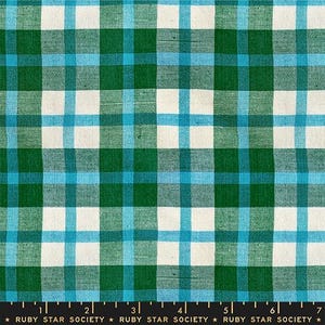 May include: A close-up of a fabric with a green, teal, and white plaid pattern. The fabric has a grid-like design with intersecting lines creating squares. The text "RUBY STAR SOCIETY" is at the bottom.