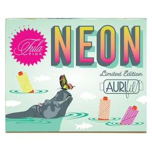 May include: A teal blue box with the words "NEON" in a retro font. The box features a pink and yellow butterfly, a hippopotamus, and spools of thread in various neon colors. The text "Limited Edition AURIfil" is also on the box.