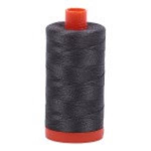May include: A spool of dark gray thread with an orange plastic bobbin.