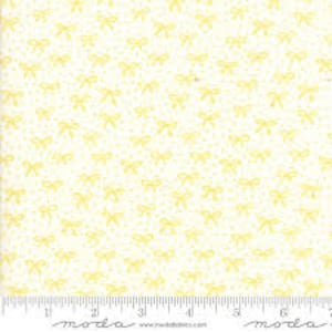 May include: White fabric with a repeating pattern of small yellow bows.