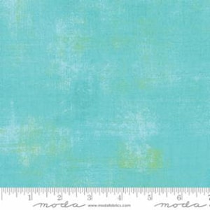 May include: A turquoise blue fabric with a subtle distressed texture and a faded green and white pattern.