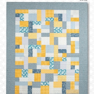 May include: A quilt pattern called "Yellow Brick Road" by Atkinson Designs. The quilt features a patchwork design with yellow, blue, and white squares. The pattern is simple and easy to follow, making it a great choice for beginner quilters.