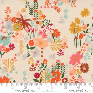 May include: Cream-colored fabric with a colorful floral pattern. The design features stylized flowers in shades of orange, pink, yellow, and teal, with green leaves and stems. The fabric has a ruler along the bottom edge.