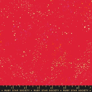 May include: Red fabric with a scattered gold and orange speckles pattern. The fabric is from Ruby Star Society.