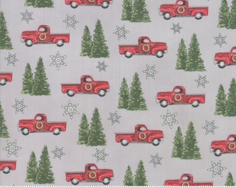 Könnte beinhalten: Rote Pickup-Trucks mit Kränzen auf der Ladefläche fahren durch einen verschneiten Wald. Die Trucks befinden sich auf einem grauen Hintergrund mit weißen Schneeflocken. Der Stoff ist perfekt zum Quilten, für Bastelarbeiten und zur Dekoration des Hauses.