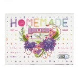 May include: A white embroidery pattern with the word "HOMEMADE" in rainbow colors and a floral design with a heart in the center. The pattern is surrounded by a dotted border.