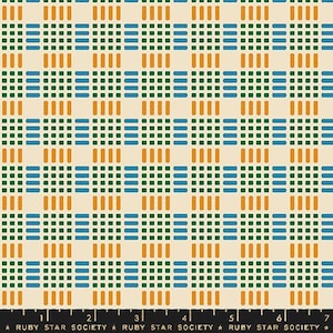 May include: A fabric with a repeating geometric pattern. The design features a grid of small squares and rectangles in shades of green, blue, and orange on a cream background. The text "RUBY STAR SOCIETY" is at the bottom.