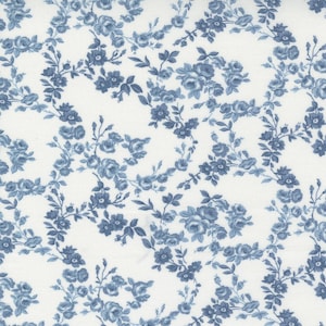 May include: A fabric with a repeating pattern of blue floral bouquets and vines on a white background. The flowers are detailed with varying shades of blue, creating a classic, vintage aesthetic. Ideal for quilting or crafting.