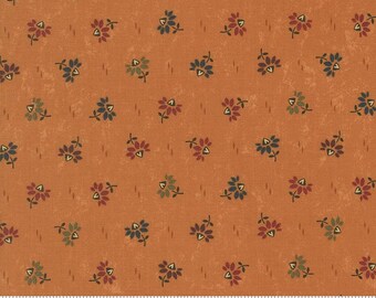 May include: Orange fabric with a repeating floral pattern. The flowers are in shades of red, blue, and green, with small leaves. The fabric has a textured appearance and a ruler at the bottom.
