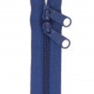 May include: A blue zipper with two metal sliders. The zipper is closed and the sliders are in the middle of the zipper.