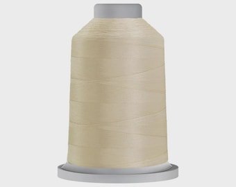 May include: A spool of beige thread, ideal for sewing and embroidery projects. The thread is tightly wound on a cylindrical spool with a gray top and base. The thread has a smooth, slightly shiny appearance.