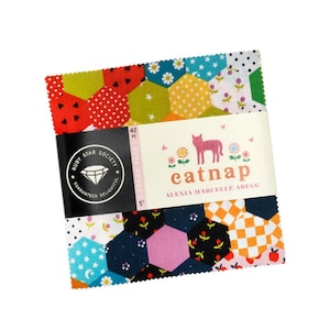 May include: A fabric charm pack with a variety of colorful, patterned, and hexagonal fabric pieces. The pack is labeled "catnap" with a pink cat illustration. The pack is 5 inches in size and contains 42 pieces.