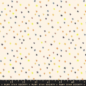 May include: A white fabric with a repeating pattern of colorful stars. The stars are in various shades of yellow, orange, brown, and blue. The fabric is perfect for quilting, sewing, and crafting.
