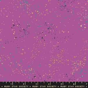 May include: A vibrant purple fabric with a speckled design. The fabric features a pattern of small, irregular dots in shades of teal, gold, and dark blue. The text "RUBY STAR SOCIETY" is printed along the bottom edge.