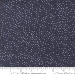 May include: A dark blue fabric with a white polka dot pattern. The fabric is textured and has a subtle sheen. The fabric is shown with a ruler for scale.