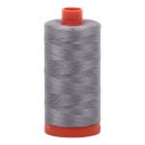 May include: A spool of gray thread with an orange base and top. The thread is tightly wound, and the spool is cylindrical. The thread appears to be made of a synthetic material. The spool is approximately 3 inches tall.