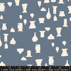May include: A fabric with a blue background featuring a pattern of off-white vase shapes in various sizes and styles. The design includes a ruler at the bottom with the text "RUBY STAR SOCIETY".
