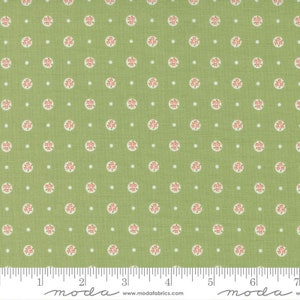 May include: Green fabric with a repeating pattern of small white dots and larger circles with pink floral designs. The fabric has a subtle texture and is perfect for quilting, sewing, and crafting projects.