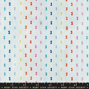 May include: White fabric with a repeating pattern of colorful, vertical dashes in shades of blue, orange, pink, yellow, and purple. The fabric has a textured appearance and is suitable for various sewing projects.