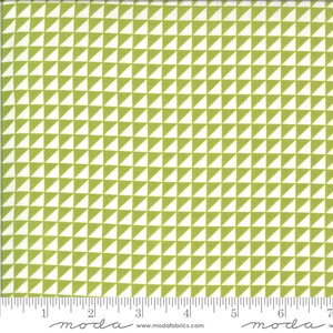 May include: White fabric with a repeating pattern of green triangles. The fabric is marked with a ruler in inches and the words "moda" and "www.modafabrics.com".