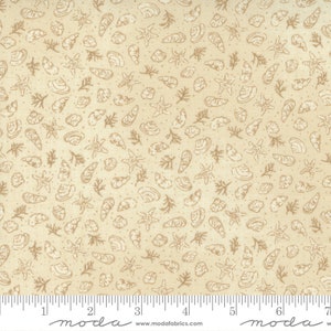 May include: Beige fabric with a repeating pattern of white seashells, starfish, and sprigs of seaweed. The fabric has a subtle texture and a slightly distressed look.