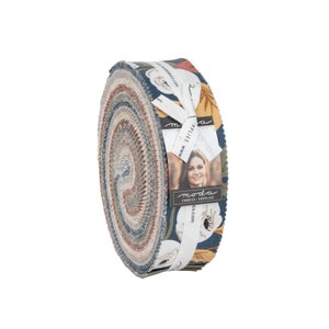 May include: A rolled fabric bundle featuring a floral pattern in shades of blue, red, and cream. The fabric is tied with a white ribbon and a tag with the brand name "Moda Fabrics". The bundle is approximately 9 inches in diameter.