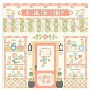 May include: A colorful quilt block depicting a flower shop with a pink door, shelves of flowers, and a sign that reads "Welcome to the Flower Shop".