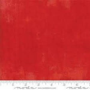 May include: Solid red fabric with a subtle textured finish. The fabric is a solid color with a slight sheen.