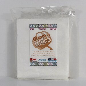 May include: A white cotton batting package labeled "Warm & White" with the text "Wonderfully White Needled Cotton Batting" and "Made in the USA from Cotton Fiber Grown & Processed in the USA".