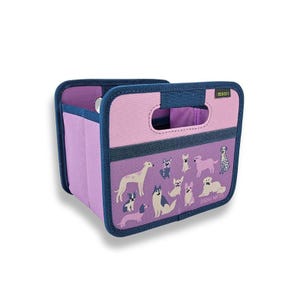 May include: A collapsible storage bin with a pink and purple color scheme, featuring a navy blue trim and handles. The front panel displays various dog illustrations. The brand name "meori" is visible on the top right.